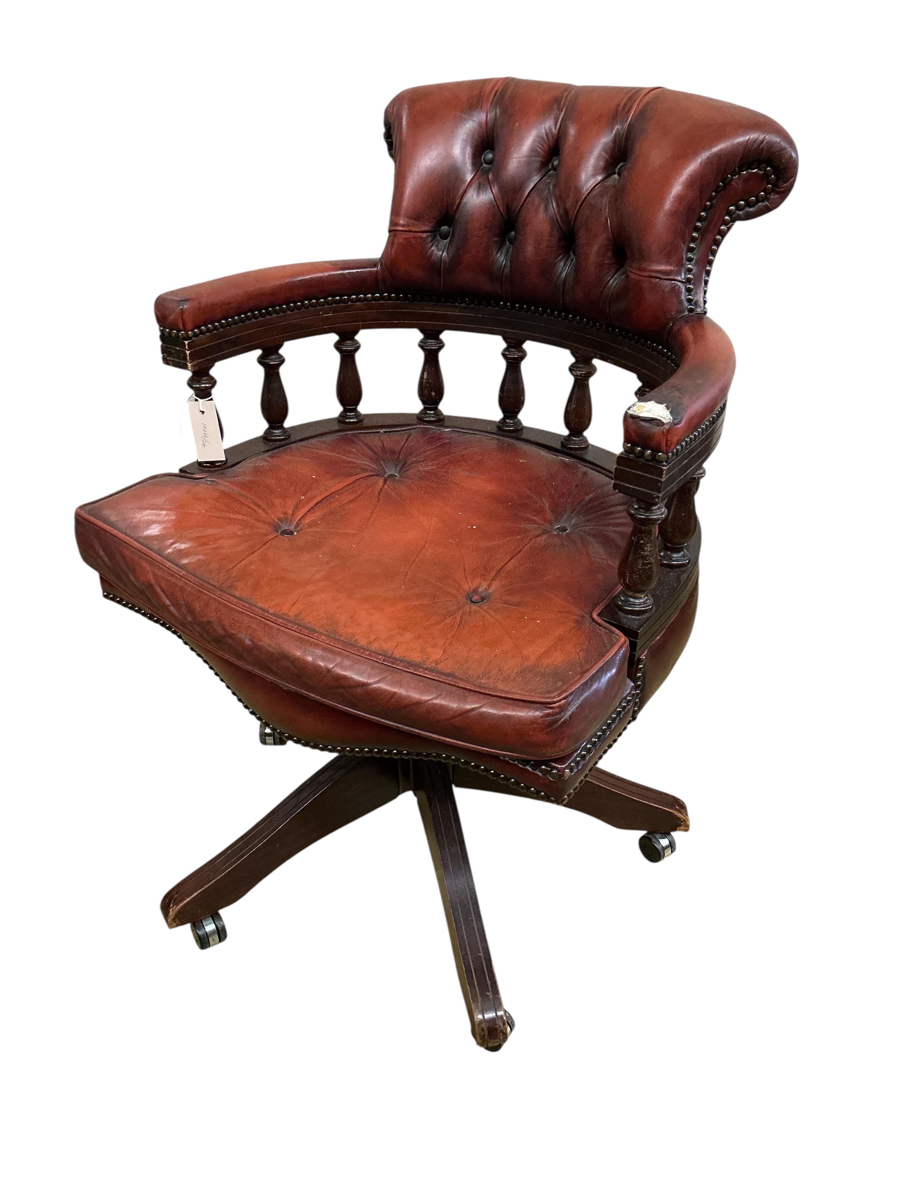 A reproduction buttoned burgundy leather swivel desk chair, width 62cm, depth 56cm, height 89cm
